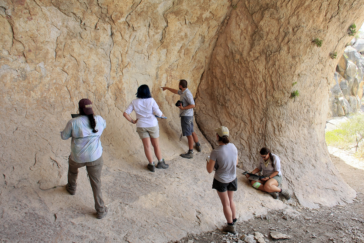 The Shumla team examines the pictographs in the upstream end of the shelter.