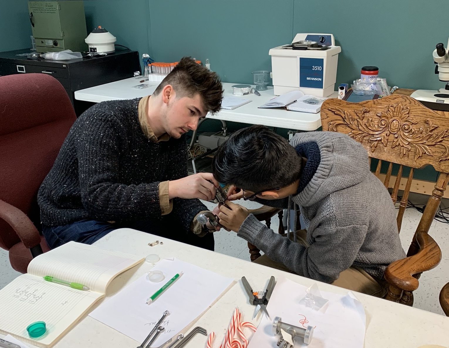Rudy (left) working with a local high-schooler (right) at Shumla's lab.